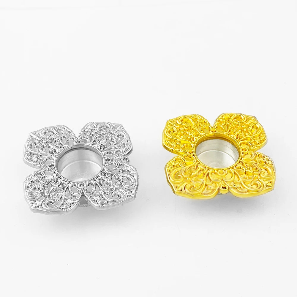 Two decorative flower-shaped Relic holders, one silver and one gold, on a white background.